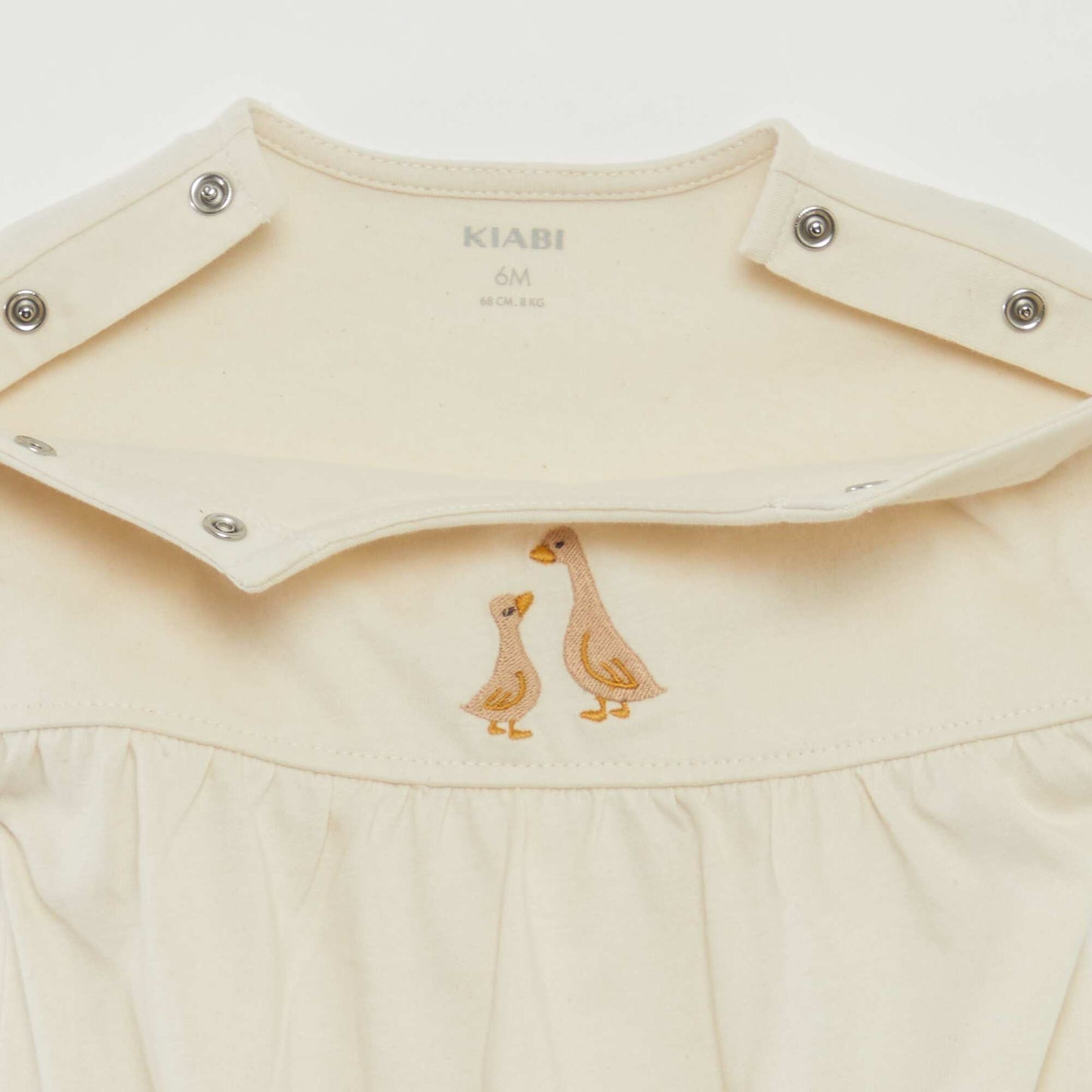Short-sleeved bodysuit with turn-ups and embroidery on the front WHITE