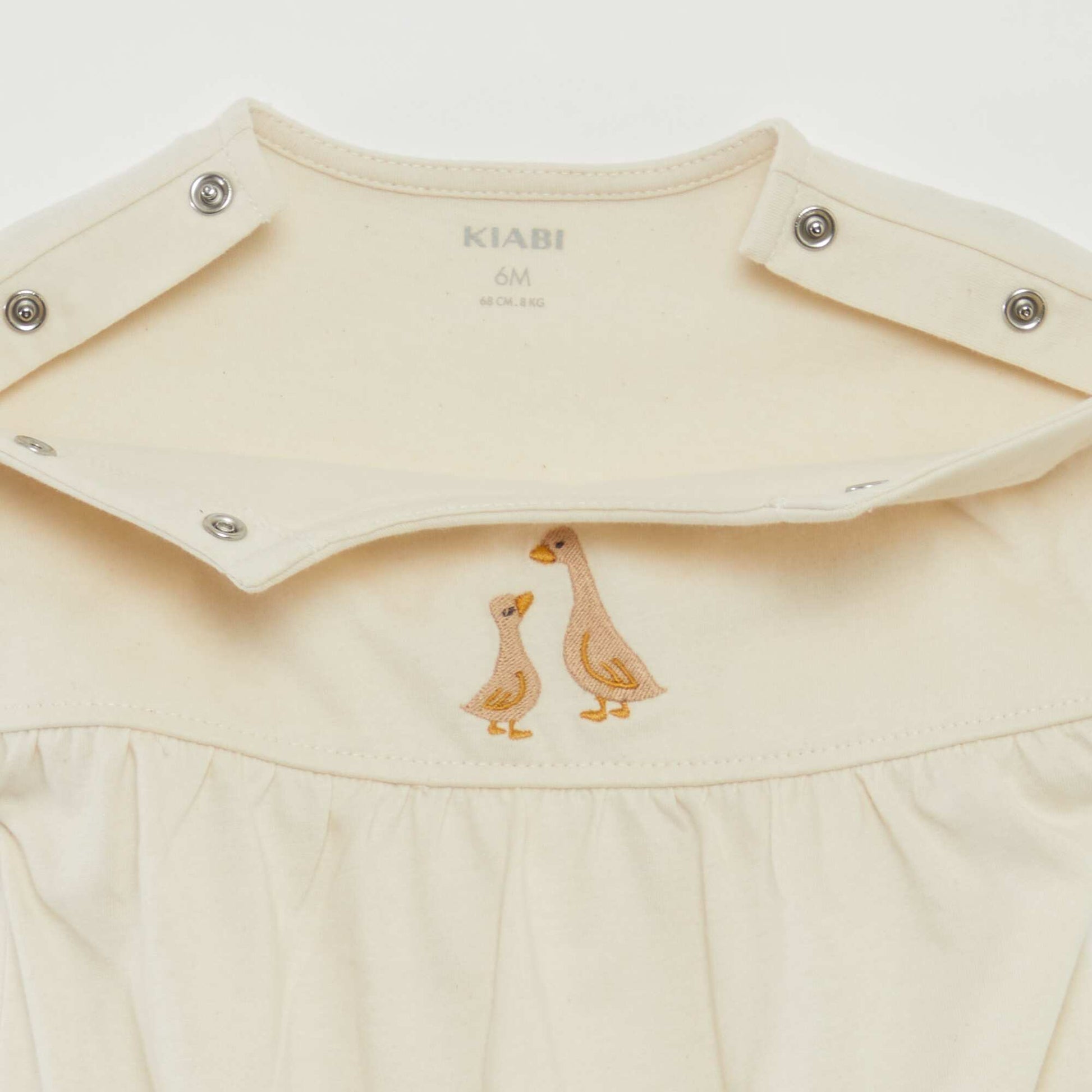 Short-sleeved bodysuit with turn-ups and embroidery on the front WHITE