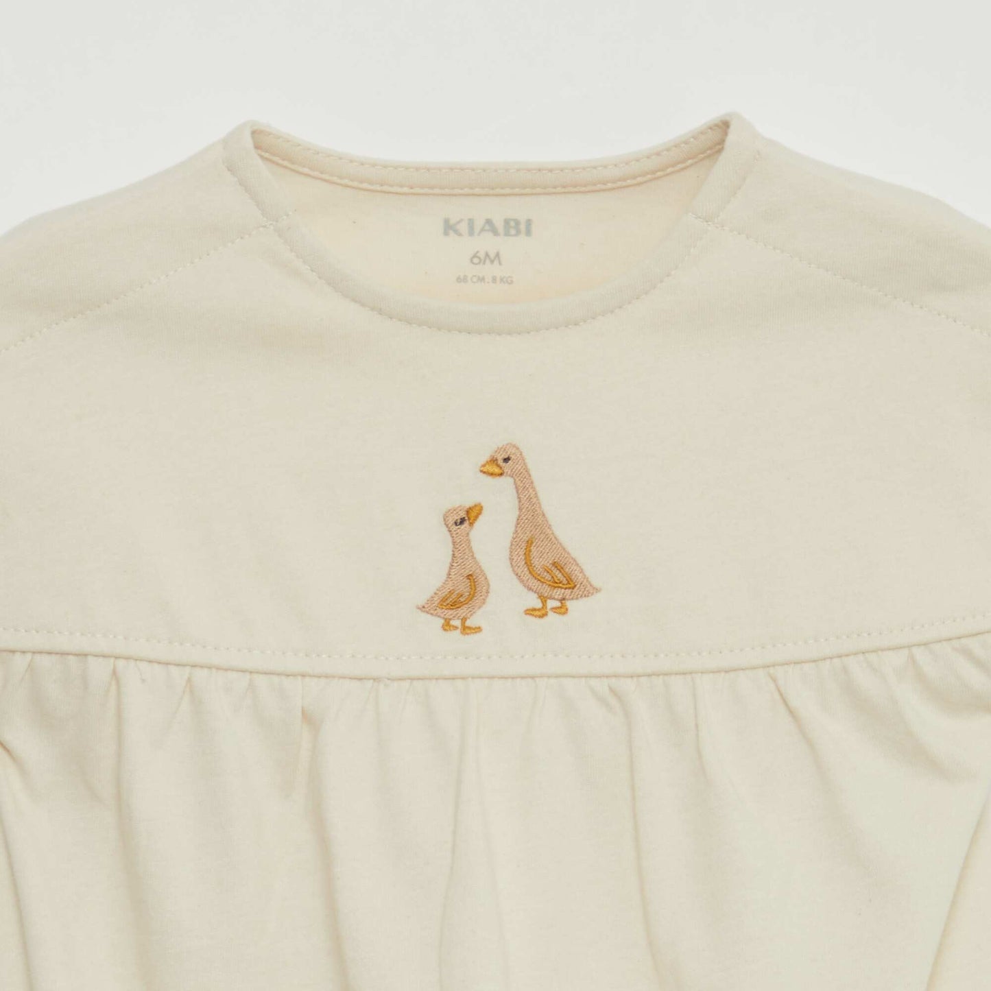 Short-sleeved bodysuit with turn-ups and embroidery on the front WHITE