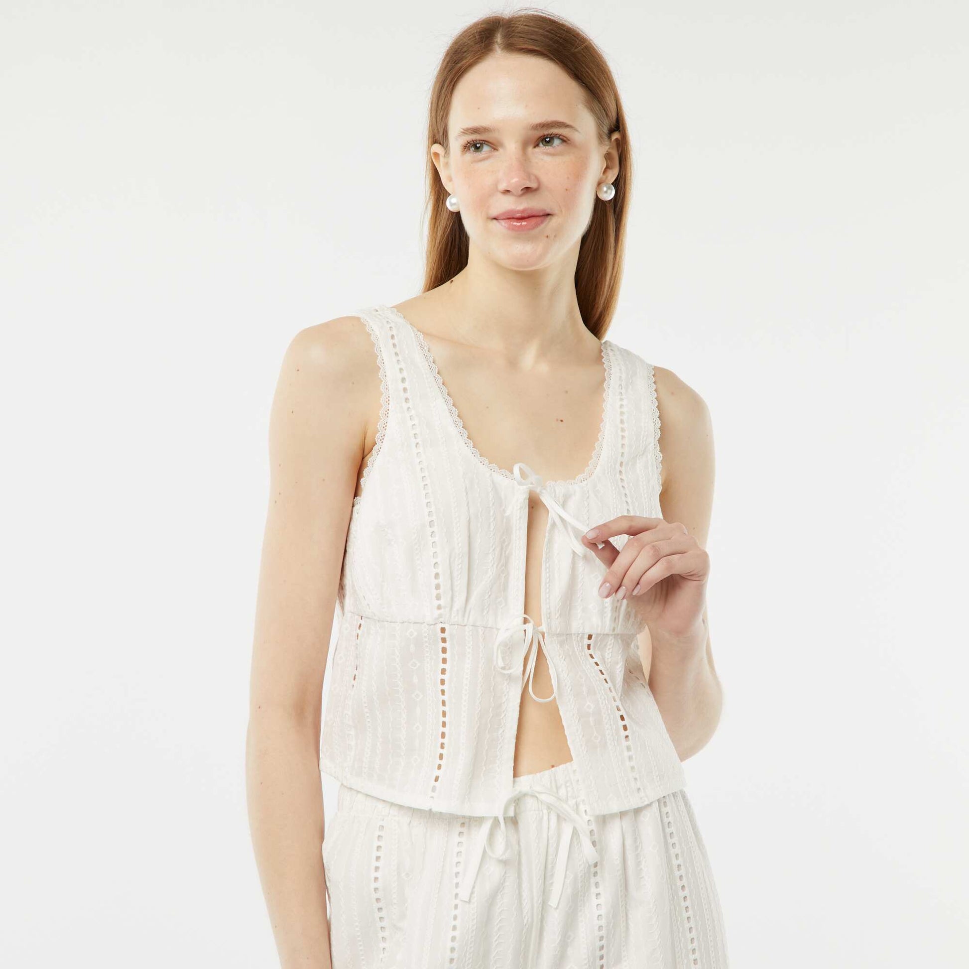 A lightweight sleeveless blouse with tie fastening and broderie anglaise WHITE